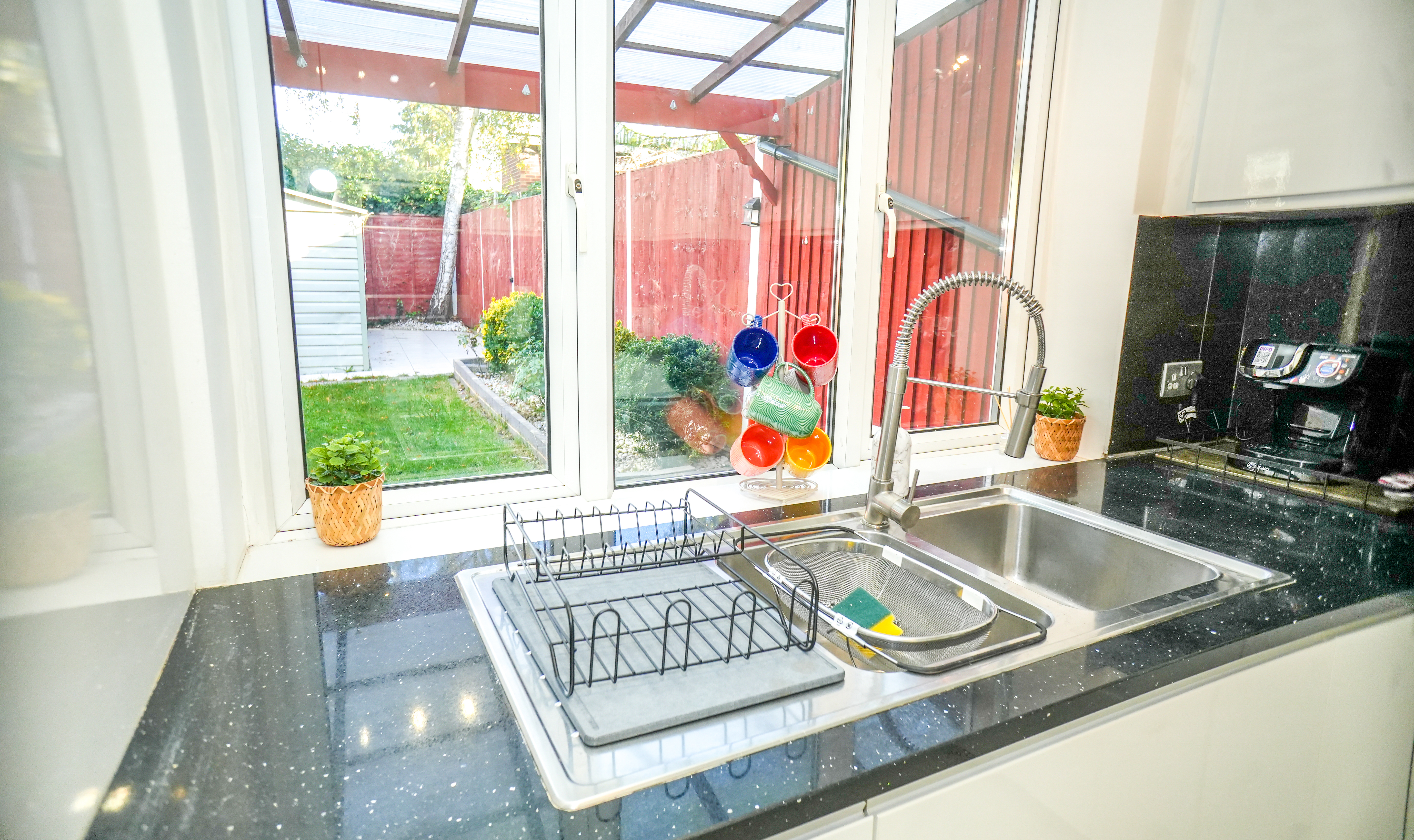 Kitchen sink and window at the Langley / Slough 3-Bedroom Home